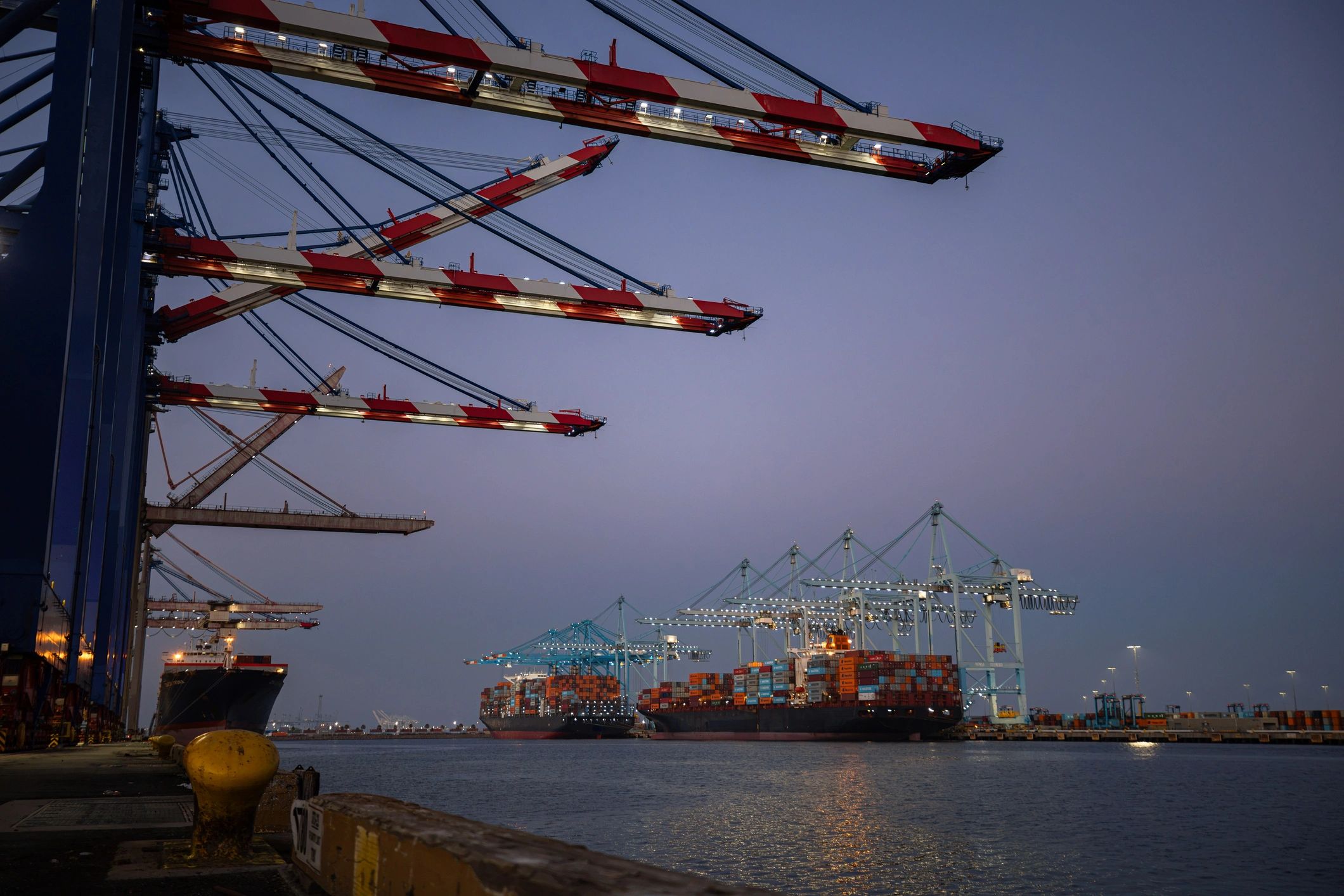 Container vessels and cranes at a busy shipping terminal